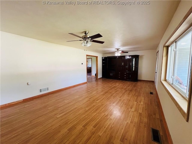 2635 Greenhills Rd, Ravenswood, WV 26164 - unfurnished living room with light wood-style flooring and a ceiling fan