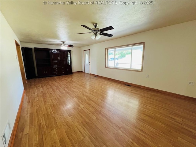 2635 Greenhills Rd, Ravenswood, WV 26164 - unfurnished living room featuring light wood-style floors and ceiling fan