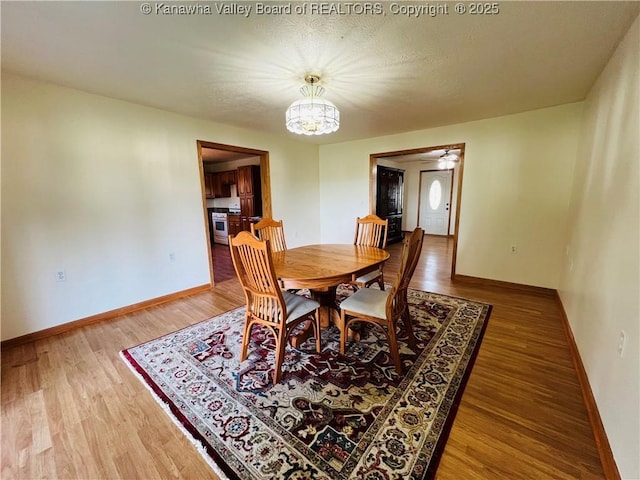 2635 Greenhills Rd, Ravenswood, WV 26164 - dining space featuring a chandelier and light wood-type flooring