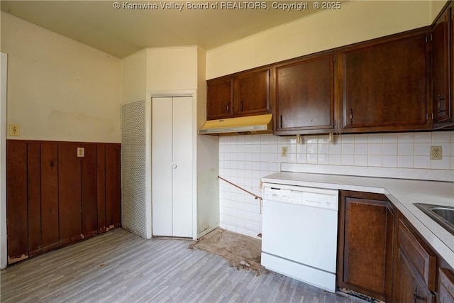 2620 Bard Ave, Saint Albans, WV 25177 - kitchen featuring dishwasher, under cabinet range hood, light countertops, wainscoting, and light wood-style flooring