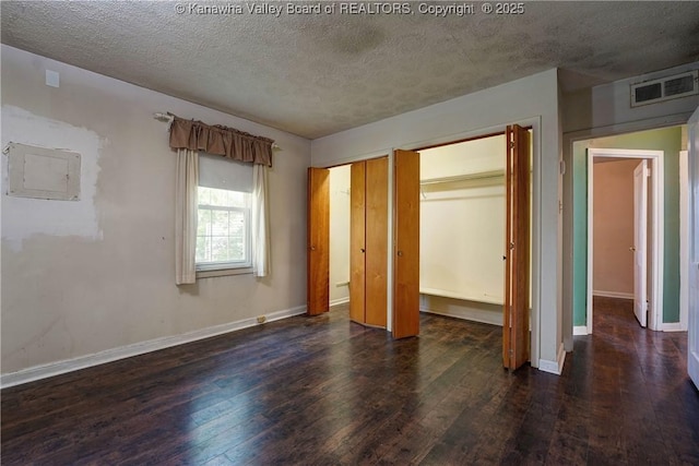 2620 Bard Ave, Saint Albans, WV 25177 - unfurnished bedroom with a textured ceiling, wood-type flooring, and multiple closets