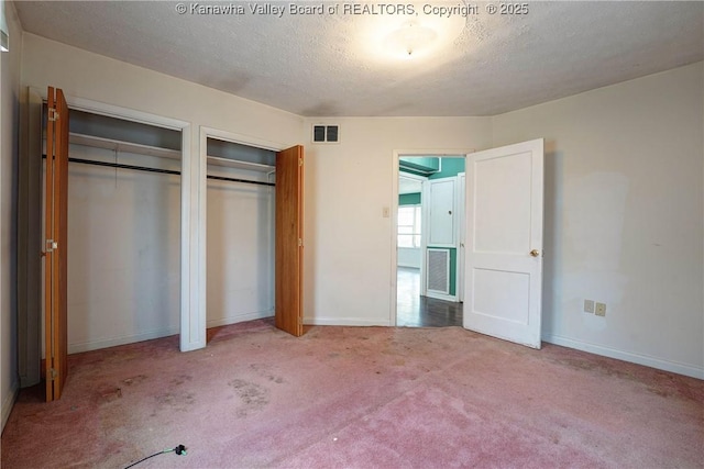 2620 Bard Ave, Saint Albans, WV 25177 - unfurnished bedroom featuring two closets, carpet floors, and a textured ceiling