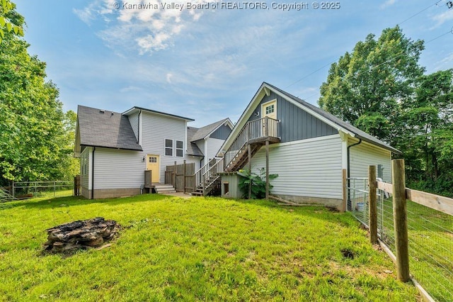 4862 Mont Union Rd, Fraziers Bottom, WV 25082 - back of house featuring stairs, a fire pit, and a shingled roof