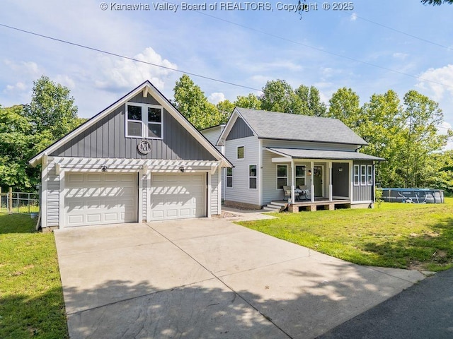 4862 Mont Union Rd, Fraziers Bottom, WV 25082 - view of front of house featuring a front yard, board and batten siding, a detached garage, and covered porch