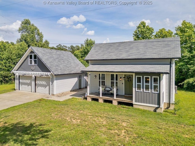4862 Mont Union Rd, Fraziers Bottom, WV 25082 - view of front of home featuring covered porch, a front yard, an outbuilding, a garage, and a shingled roof
