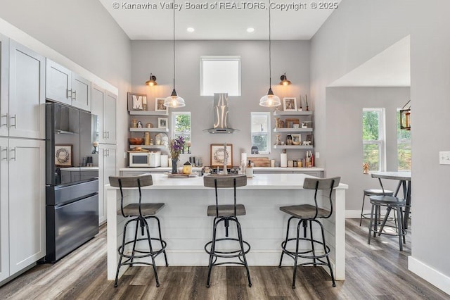 4862 Mont Union Rd, Fraziers Bottom, WV 25082 - kitchen with high end refrigerator, open shelves, white microwave, light countertops, and wood finished floors