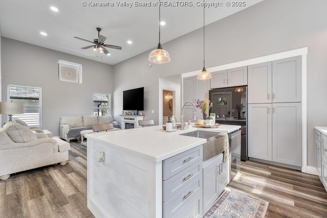 4862 Mont Union Rd, Fraziers Bottom, WV 25082 - kitchen featuring a ceiling fan, light wood-style floors, a high ceiling, light countertops, and open floor plan