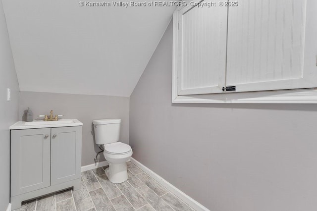 4862 Mont Union Rd, Fraziers Bottom, WV 25082 - half bath featuring lofted ceiling, vanity, and wood tiled floors