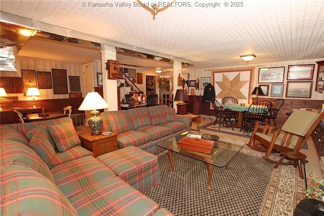 5445 Longview Dr, Cross Lanes, WV 25313 - living room featuring carpet floors, decorative columns, and wooden walls