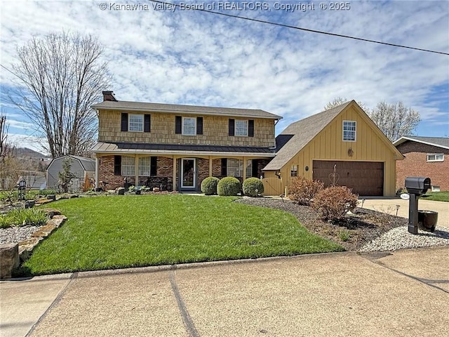 5445 Longview Dr, Cross Lanes, WV 25313 - traditional home with driveway, a front yard, a chimney, and a garage