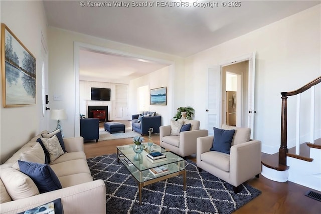 927 Ridgemont Rd, Charleston, WV 25314 - living room with wood finished floors, stairs, and a fireplace
