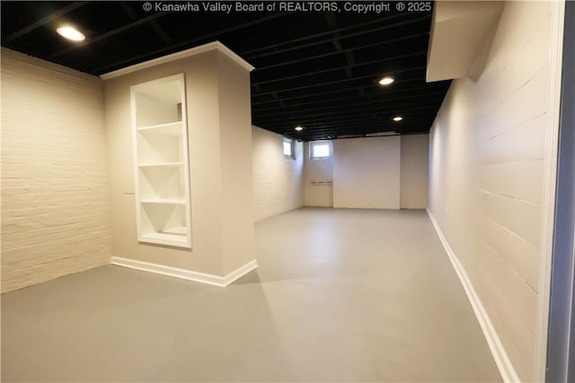 927 Ridgemont Rd, Charleston, WV 25314 - corridor featuring finished concrete flooring and brick wall