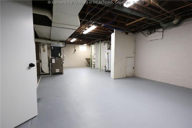 927 Ridgemont Rd, Charleston, WV 25314 - unfinished below grade area with water heater, brick wall, and heating unit