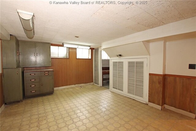 4312 Lancaster Ave, Charleston, WV 25304 - below grade area featuring wood walls, light flooring, and wainscoting