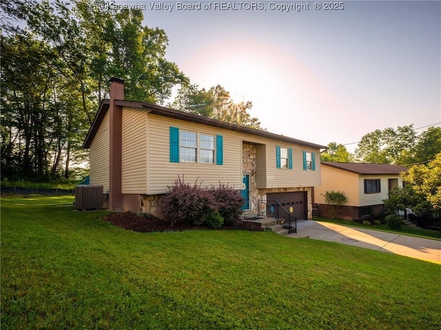 150 Timberlake Cir, Scott Depot, WV 25560 - bi-level home featuring a chimney, a garage, concrete driveway, and a front lawn