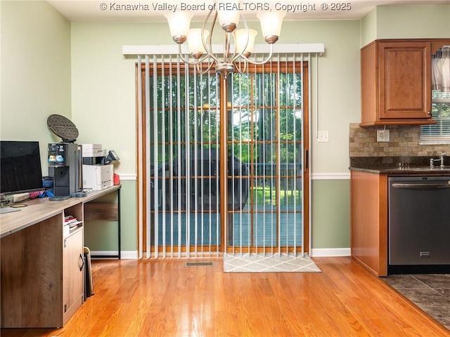 150 Timberlake Cir, Scott Depot, WV 25560 - kitchen featuring stainless steel dishwasher, light wood-style floors, a chandelier, brown cabinetry, and tasteful backsplash