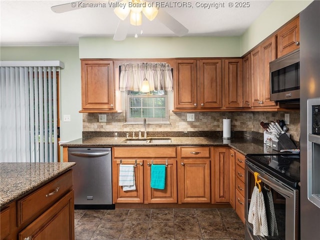 150 Timberlake Cir, Scott Depot, WV 25560 - kitchen featuring stainless steel appliances, tasteful backsplash, ceiling fan, brown cabinetry, and dark stone countertops