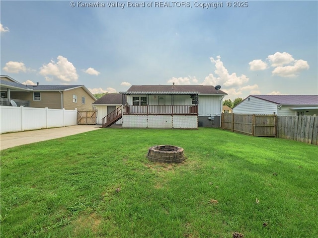 123 Dodd St, Poca, WV 25159 - back of house featuring a fenced backyard, a fire pit, a patio, and a deck