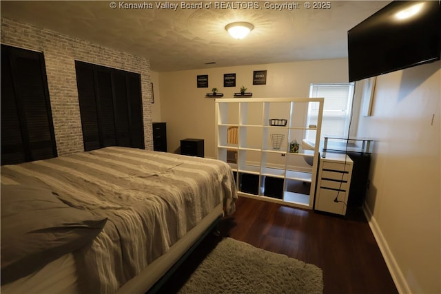 442 Porter Rd, Charleston, WV 25314 - bedroom with wood finished floors, brick wall, and a textured ceiling