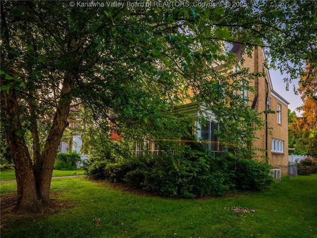 623 11th Ave, Huntington, WV 25701 - view of property exterior with a yard, a chimney, and brick siding