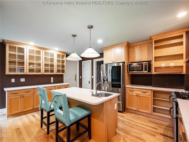 623 11th Ave, Huntington, WV 25701 - kitchen with appliances with stainless steel finishes, open shelves, light wood-type flooring, light countertops, and recessed lighting