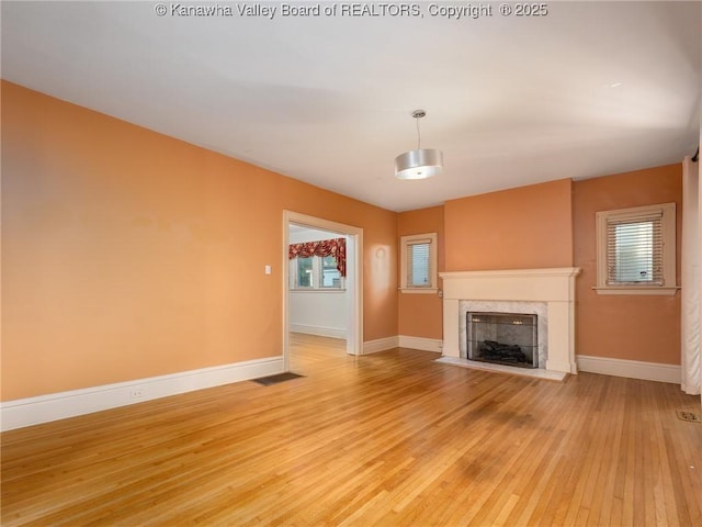 623 11th Ave, Huntington, WV 25701 - unfurnished living room featuring light wood-style flooring and a premium fireplace