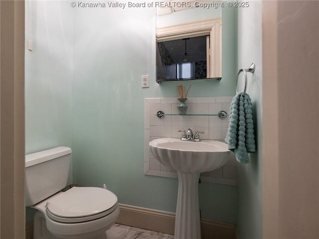 623 11th Ave, Huntington, WV 25701 - half bathroom featuring toilet and backsplash