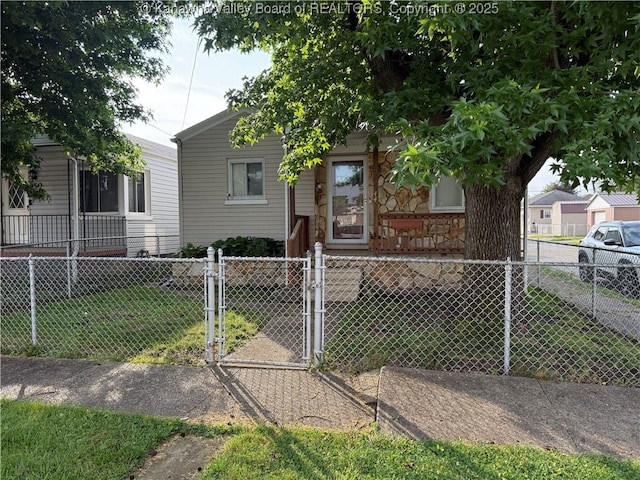 448 18th St, Dunbar, WV 25064 - view of front of house featuring a fenced front yard, a gate, and stone siding