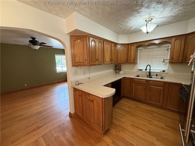 448 18th St, Dunbar, WV 25064 - kitchen with light wood-style floors, black dishwasher, brown cabinets, ceiling fan, and a textured ceiling