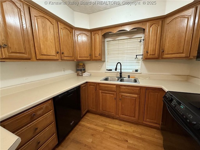 448 18th St, Dunbar, WV 25064 - kitchen featuring black appliances, light wood-style flooring, brown cabinets, and light countertops
