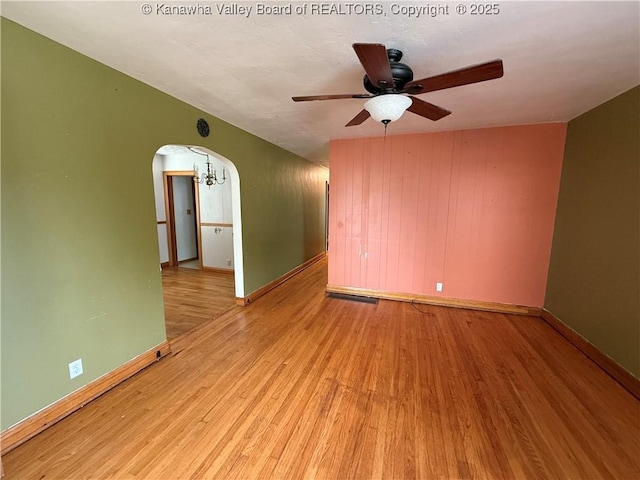 448 18th St, Dunbar, WV 25064 - empty room featuring arched walkways, wood finished floors, and ceiling fan
