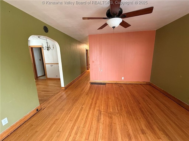 448 18th St, Dunbar, WV 25064 - spare room with arched walkways, wood finished floors, and a ceiling fan