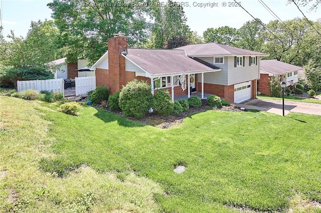 1501 Brentwood Rd, Charleston, WV 25314 - split level home with brick siding, driveway, an attached garage, a chimney, and covered porch