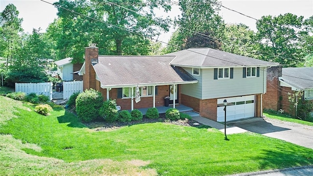 1501 Brentwood Rd, Charleston, WV 25314 - split level home with concrete driveway, a porch, a garage, a chimney, and brick siding