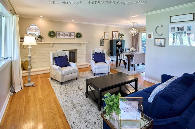 1501 Brentwood Rd, Charleston, WV 25314 - living room featuring wood finished floors, a chandelier, crown molding, a brick fireplace, and recessed lighting