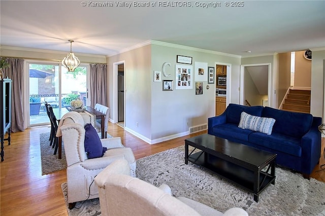 1501 Brentwood Rd, Charleston, WV 25314 - living room with a chandelier, ornamental molding, stairway, and light wood-type flooring