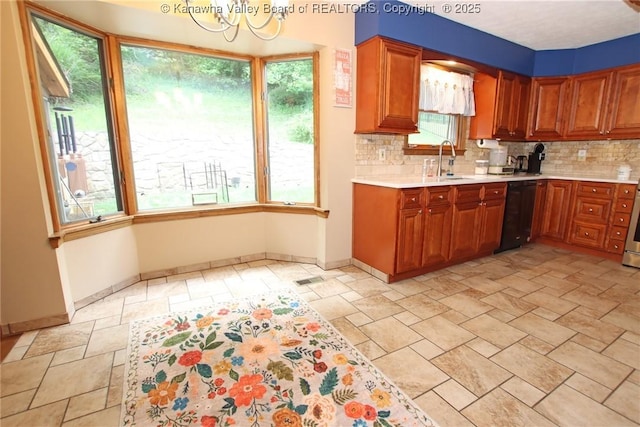 119 Falls Run Rd, Charleston, WV 25311 - kitchen featuring black dishwasher, light countertops, stone tile flooring, and backsplash