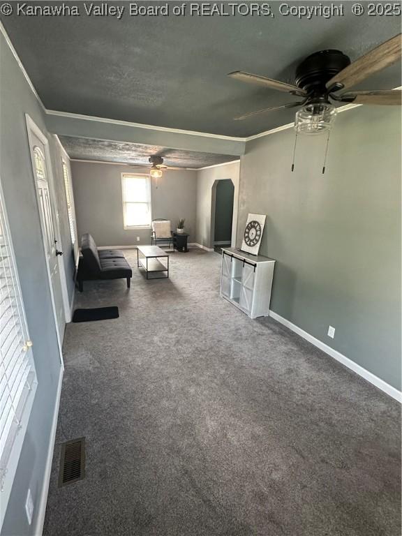 1110 Benamati Ave, Nitro, WV 25143 - carpeted living room featuring a ceiling fan, arched walkways, and ornamental molding