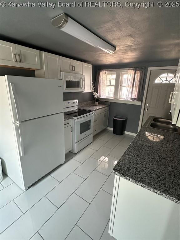 1110 Benamati Ave, Nitro, WV 25143 - kitchen with white appliances, white cabinetry, and dark stone counters