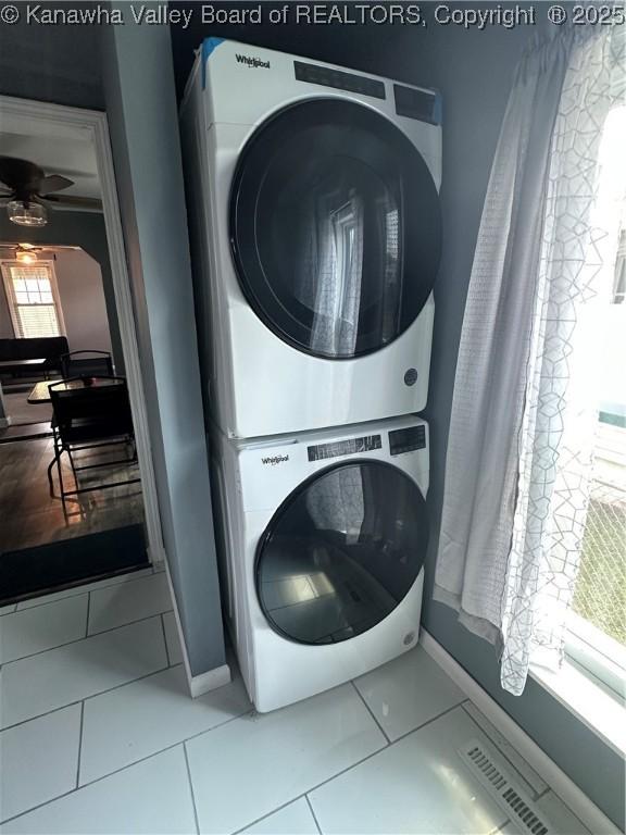 1110 Benamati Ave, Nitro, WV 25143 - laundry room with stacked washer and clothes dryer, tile patterned floors, and a ceiling fan