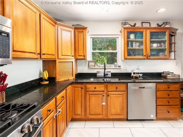 1105 Hollyberry Ln, South Charleston, WV 25309 - kitchen featuring appliances with stainless steel finishes, light tile patterned flooring, dark stone counters, brown cabinetry, and recessed lighting