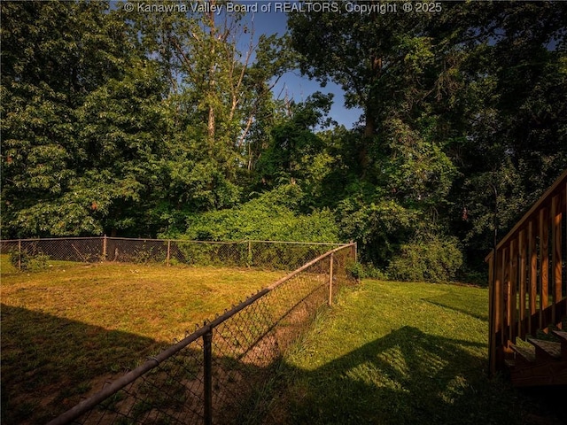 1105 Hollyberry Ln, South Charleston, WV 25309 - fenced backyard featuring a wooded view