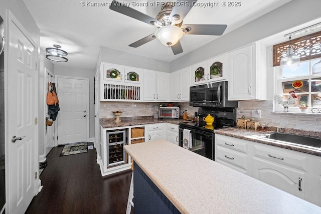 128 Westland Ests, Winfield, WV 25213 - kitchen featuring stainless steel microwave, beverage cooler, black range with electric stovetop, and white cabinetry