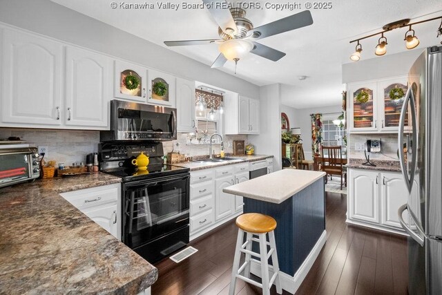 128 Westland Ests, Winfield, WV 25213 - kitchen with stainless steel appliances, white cabinets, and decorative backsplash