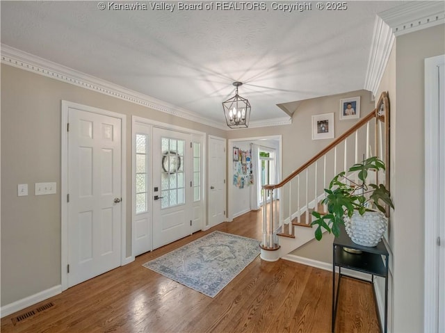 52 Cedar Dr, Hurricane, WV 25526 - entryway with crown molding, stairs, a chandelier, and wood finished floors