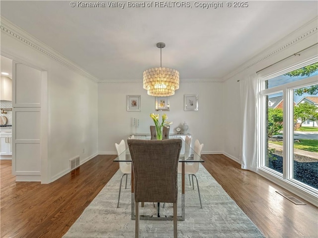 52 Cedar Dr, Hurricane, WV 25526 - dining space featuring a chandelier, wood finished floors, and ornamental molding