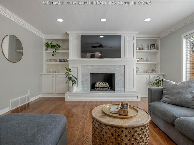 52 Cedar Dr, Hurricane, WV 25526 - living area featuring a fireplace with raised hearth, ornamental molding, wood finished floors, a ceiling fan, and recessed lighting