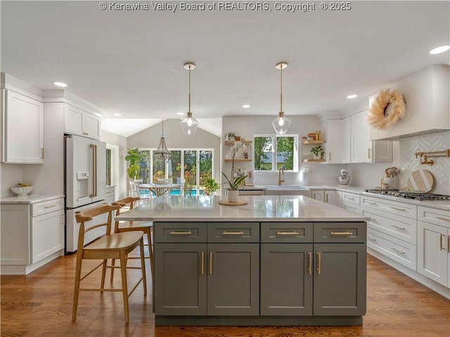 52 Cedar Dr, Hurricane, WV 25526 - kitchen with high end fridge, open shelves, white cabinetry, light countertops, and stainless steel gas stovetop