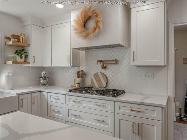 52 Cedar Dr, Hurricane, WV 25526 - kitchen featuring stainless steel gas stovetop, white cabinetry, open shelves, and decorative backsplash
