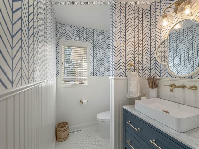 52 Cedar Dr, Hurricane, WV 25526 - bathroom featuring wallpapered walls, vanity, tile patterned flooring, and wainscoting